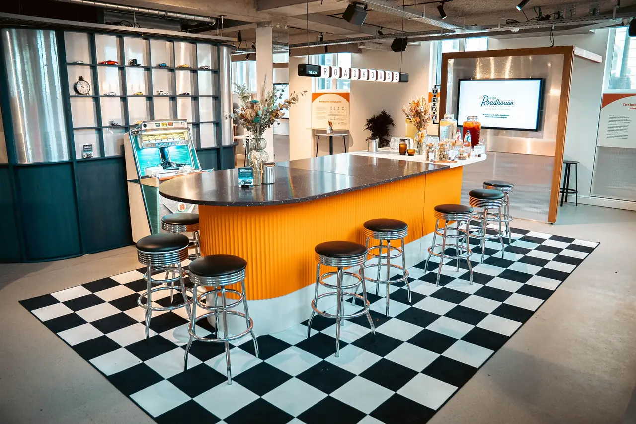 The ACEA Roadhouse bar, with chrome stools and a chequerboard floor