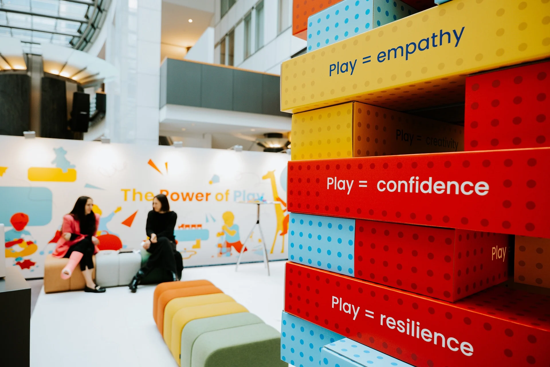 The Power of Play exhibition, with the giant block tower and the exhibition wall behind