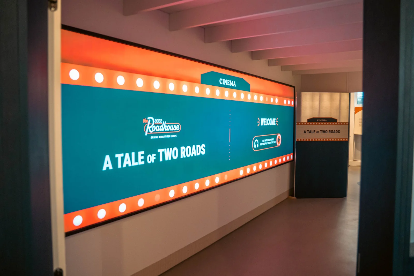 An illuminated sign reading A Tale of Two Roads