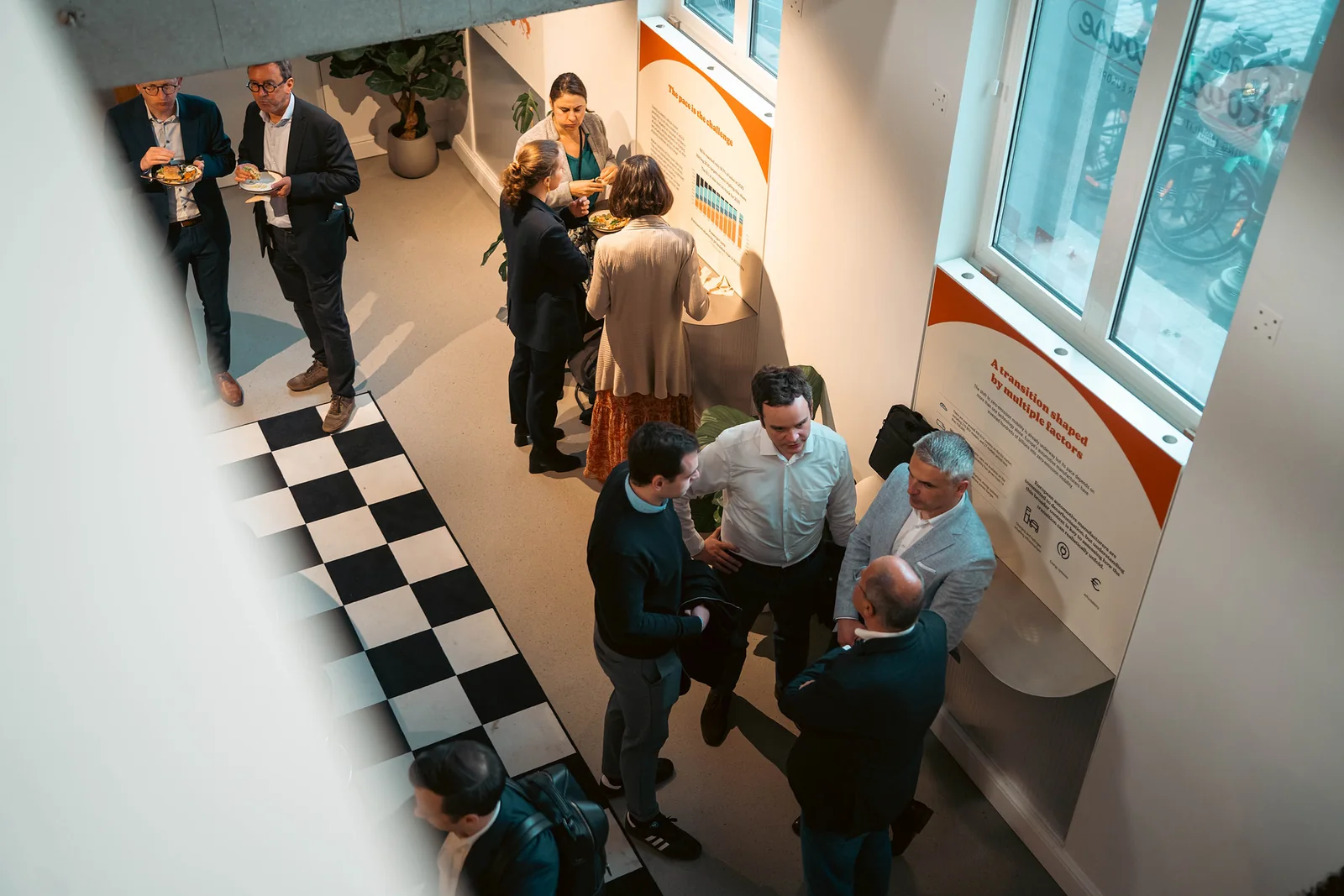 Looking down on guests talking across the chequerboard floor