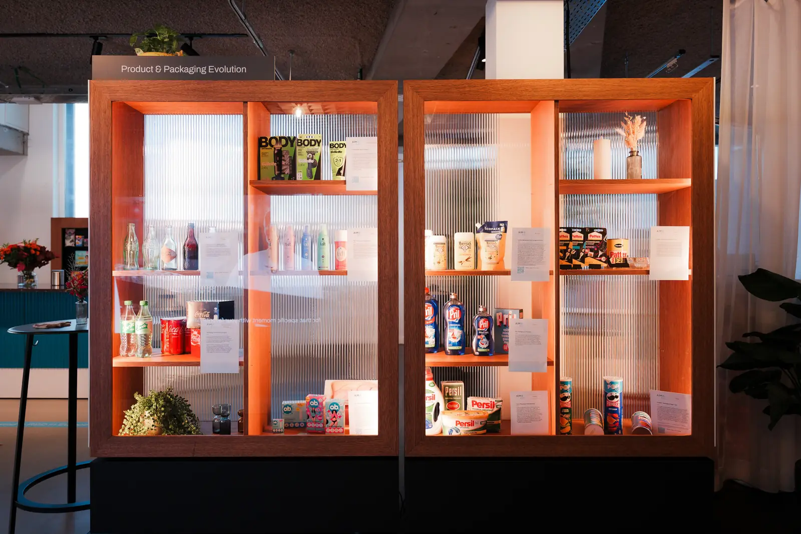 Product and packaging evolution cabinets lit in warm orange