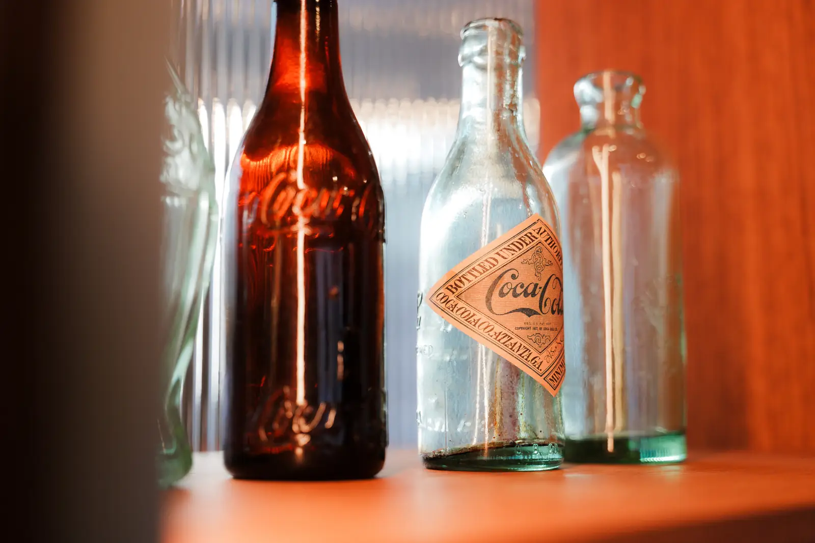 Vintage Coca-Cola bottles on a display shelf