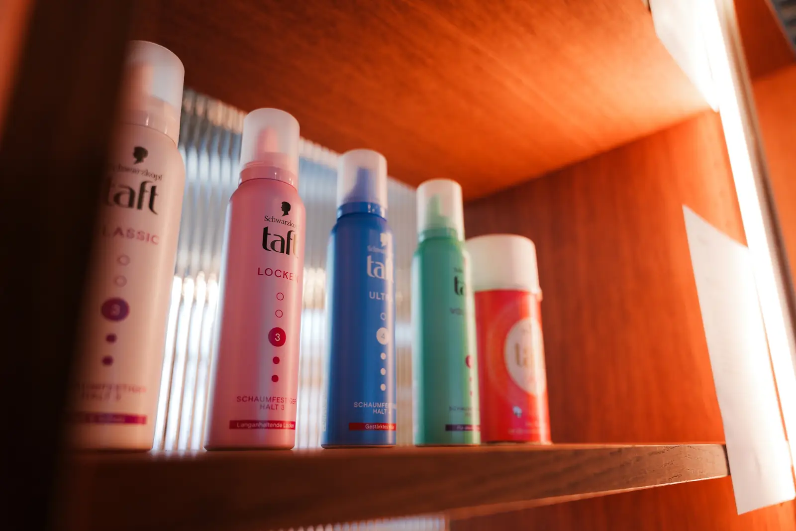 A row of Taft hairspray cans showing how the packaging has changed