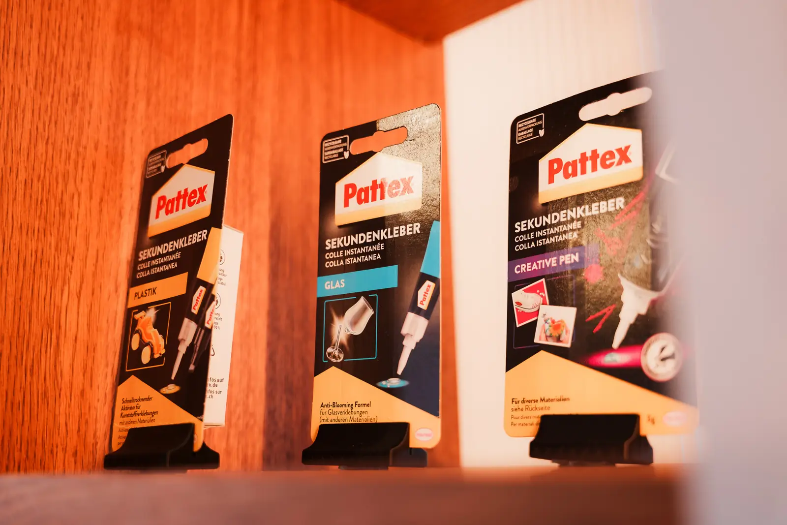 Pattex adhesive packs on a display shelf