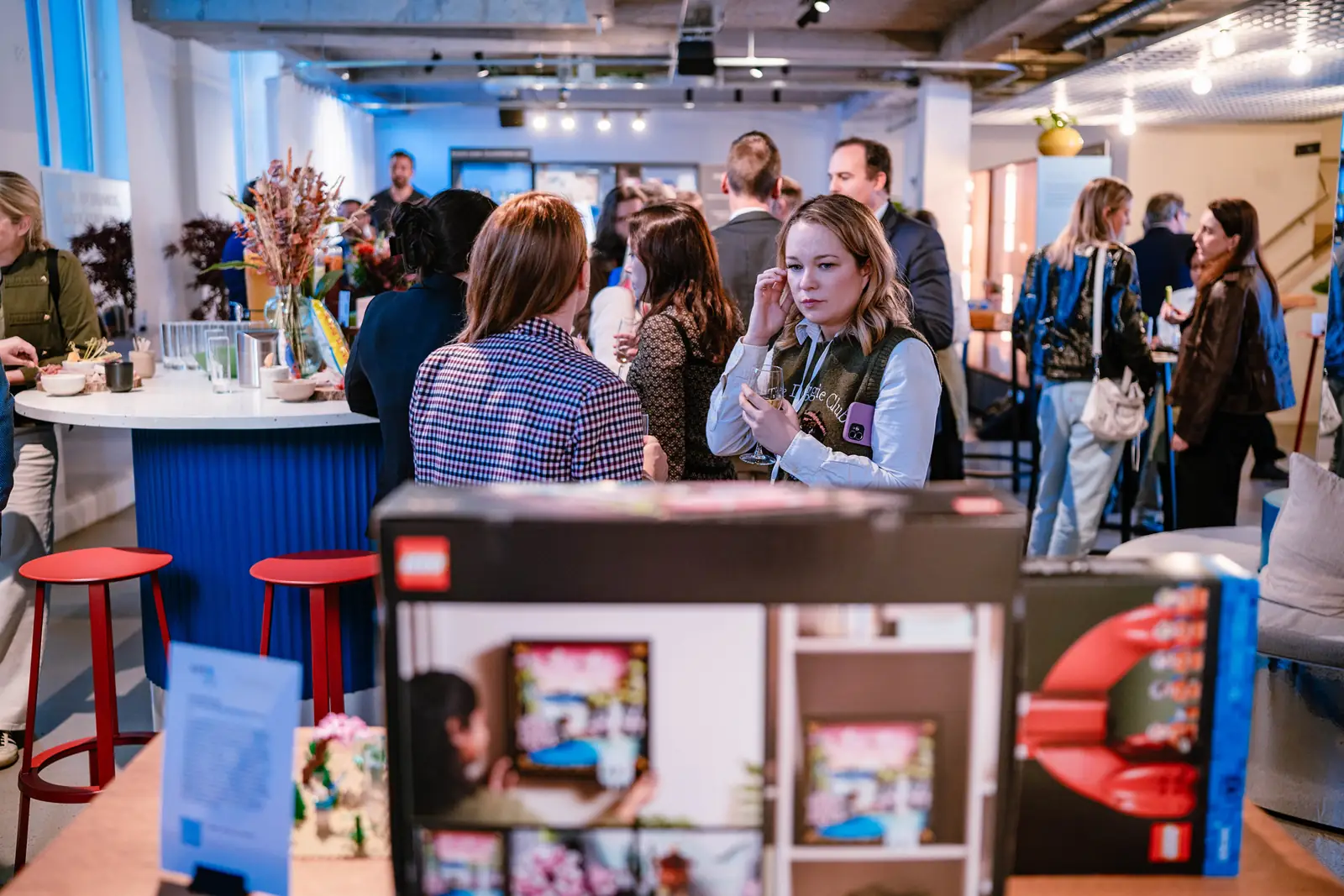 Guests in conversation beside a display of branded products