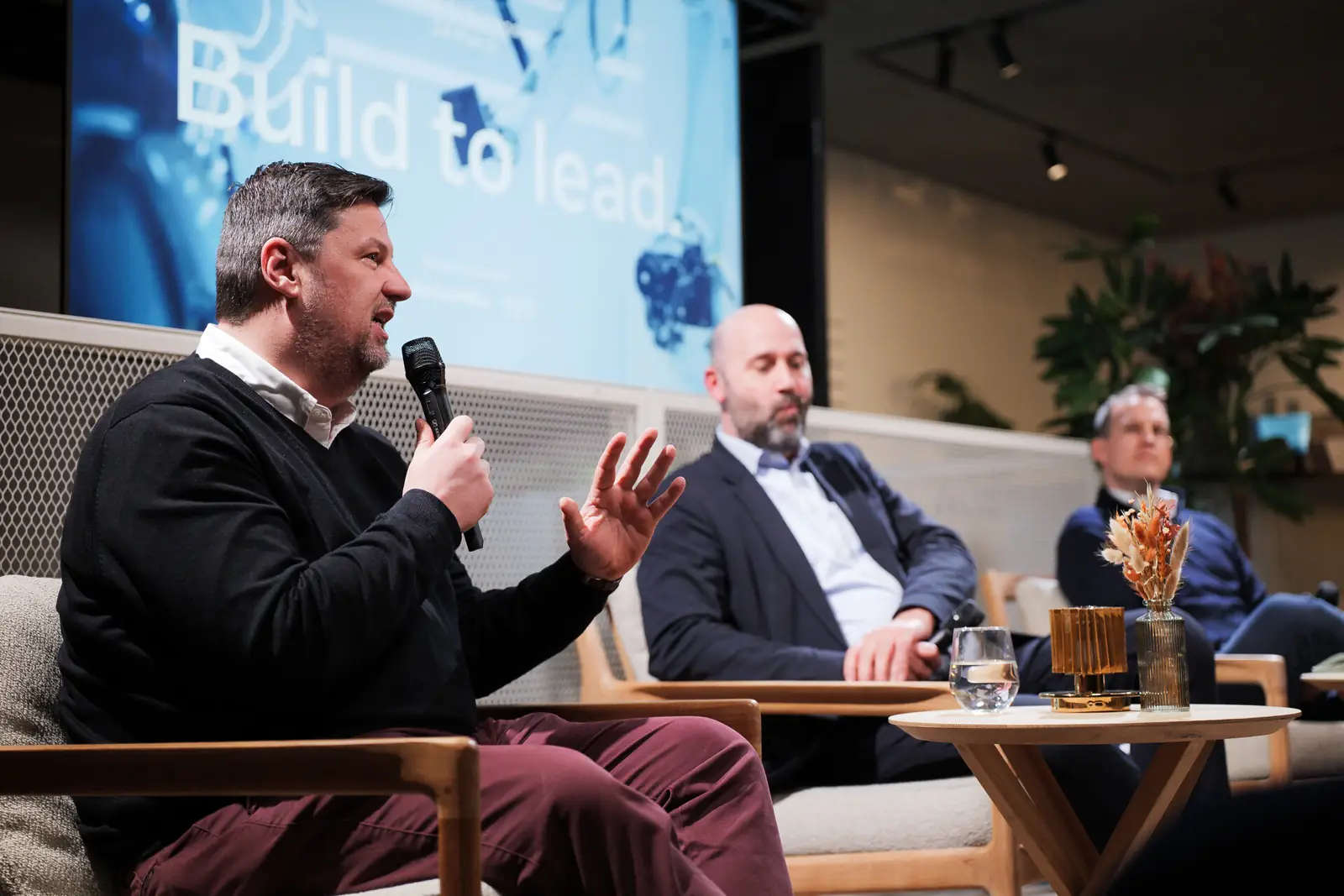 A panellist speaking on the lounge set