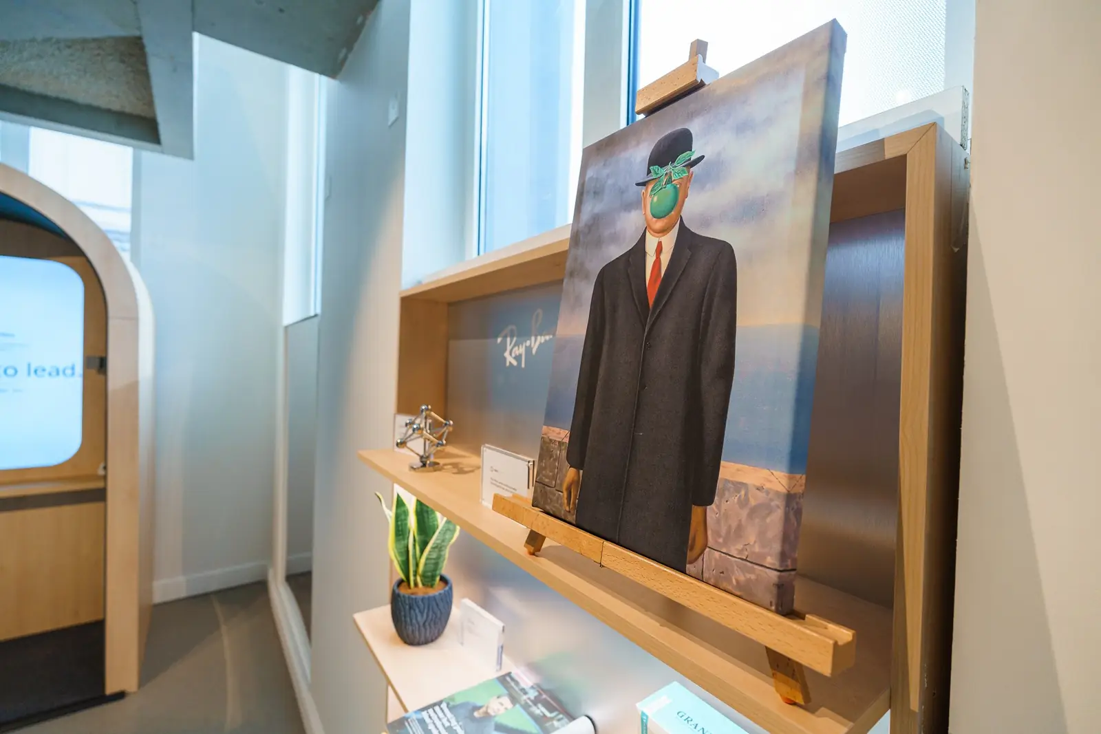 A Magritte-style painting on an easel in the eyewear display