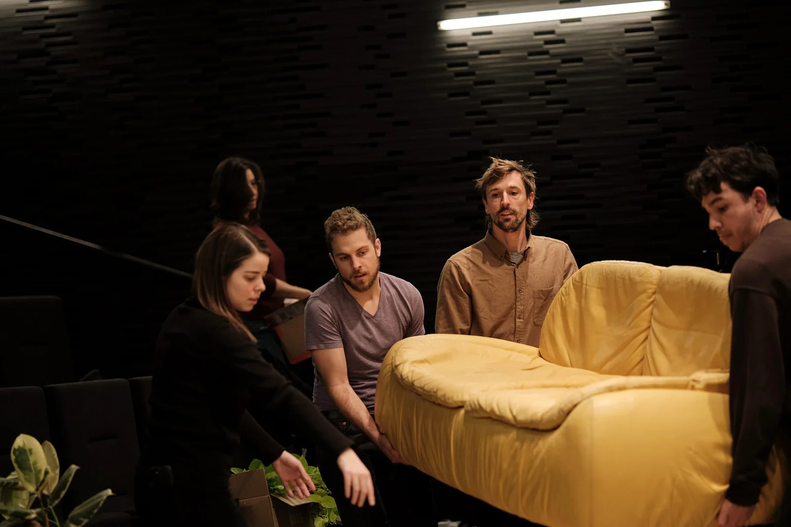 The group talking around the sofa between sessions