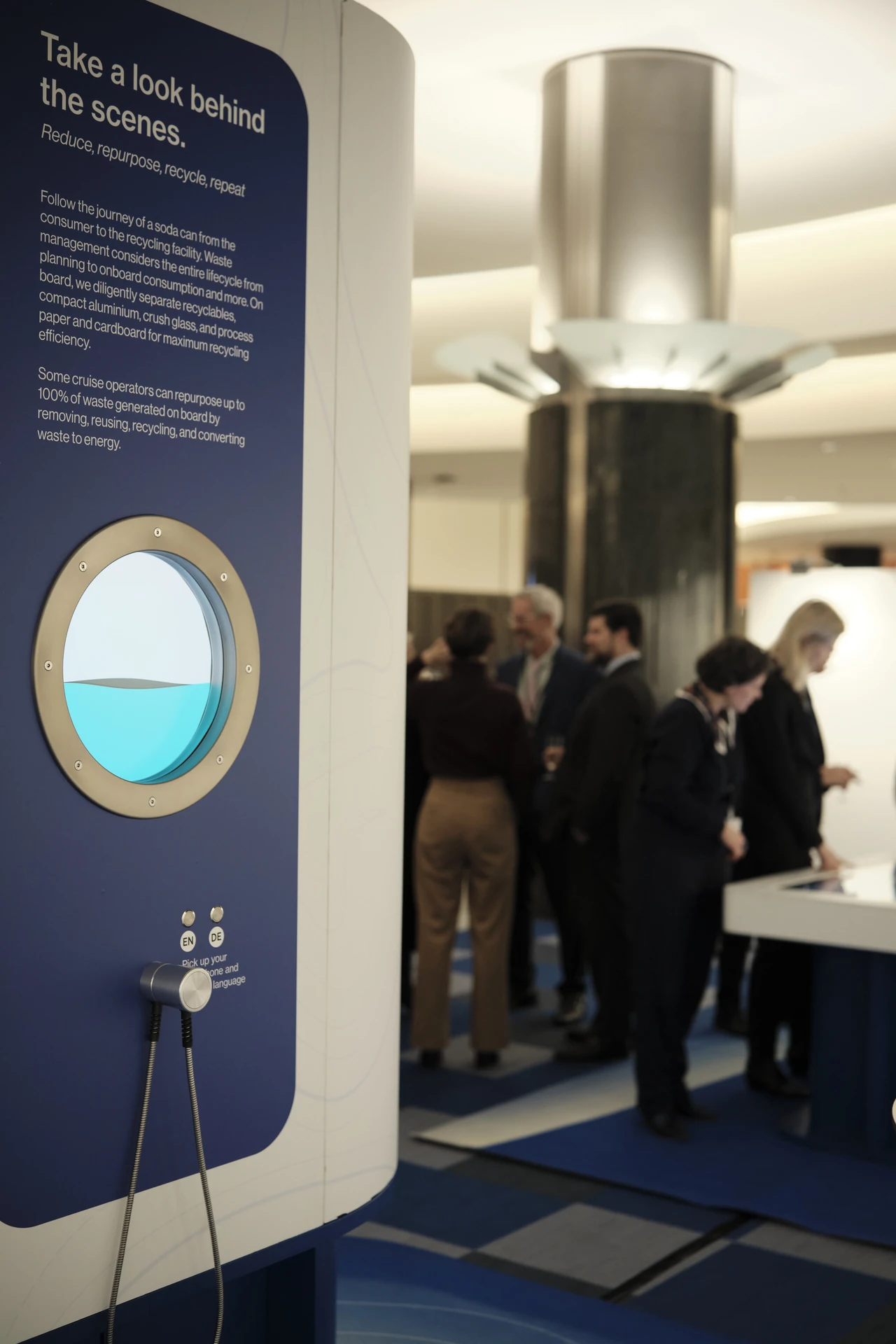 The porthole video experience and its handset, with guests at the installation behind