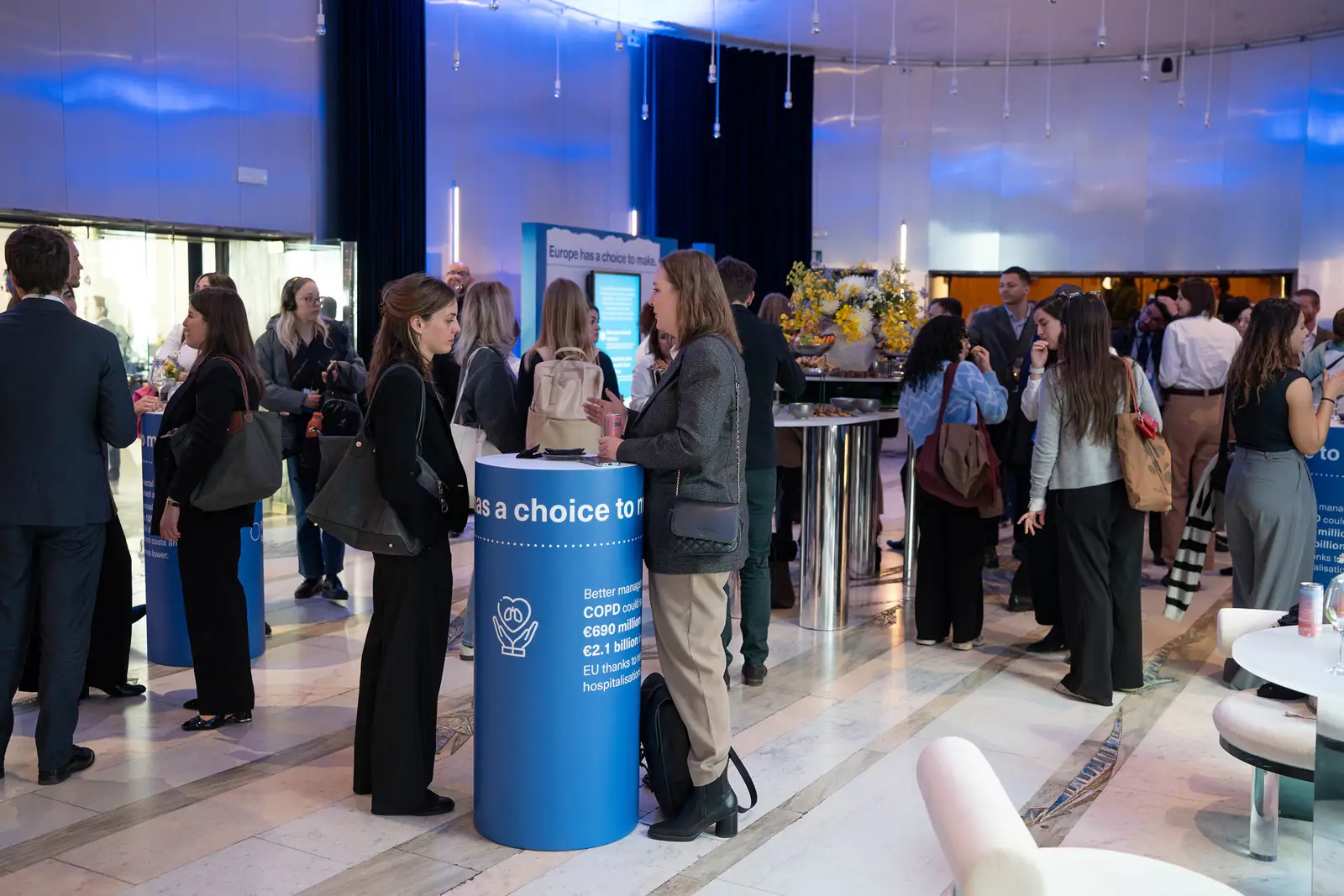 Guests networking around a Europe&rsquo;s Choice information column