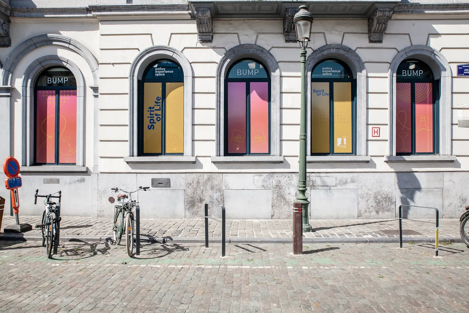 The Bump Policy Experience Space from Place du Luxembourg, its arched windows dressed in Spirit of Life colours